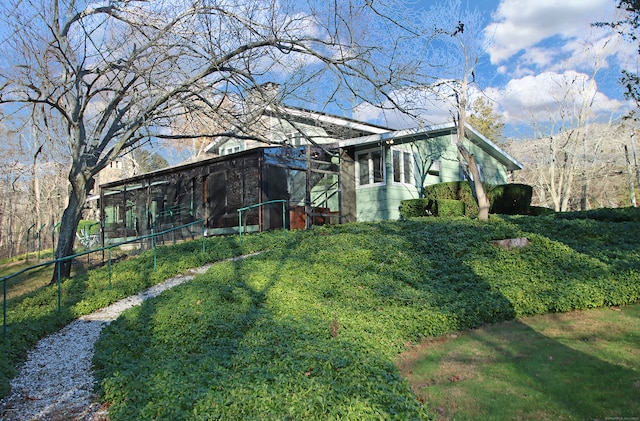 view of side of home with a sunroom