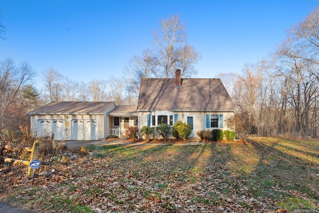 view of front of home with a garage and a front lawn