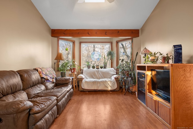 living room with hardwood / wood-style floors and lofted ceiling with beams