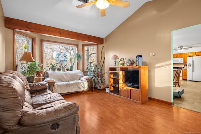 living room featuring high vaulted ceiling, light hardwood / wood-style flooring, and ceiling fan