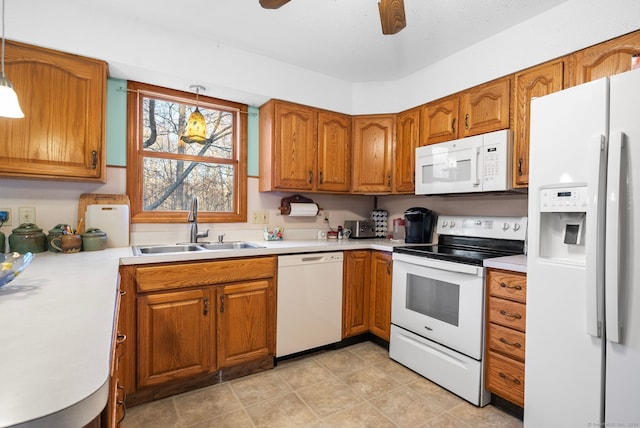 kitchen featuring ceiling fan, sink, white appliances, and hanging light fixtures