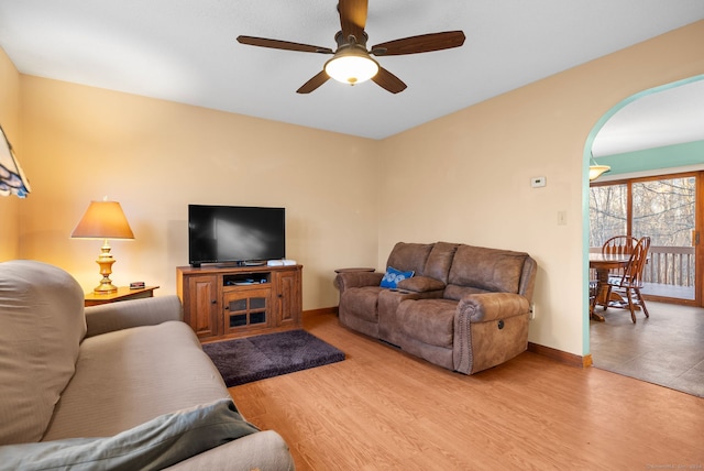 living room featuring ceiling fan and wood-type flooring