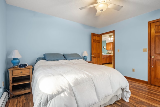 bedroom with ceiling fan, wood-type flooring, and a textured ceiling