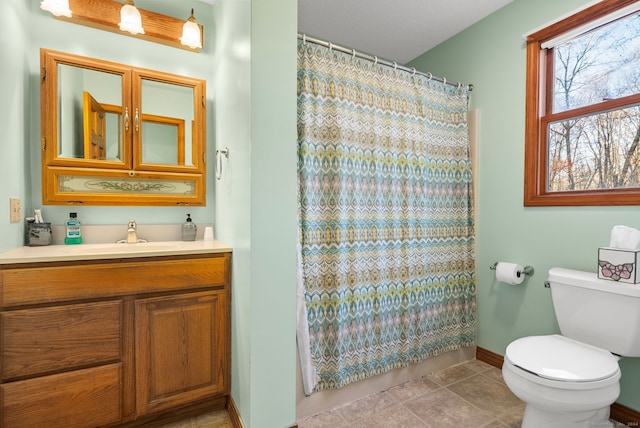 bathroom with tile patterned floors, a shower with curtain, vanity, and toilet