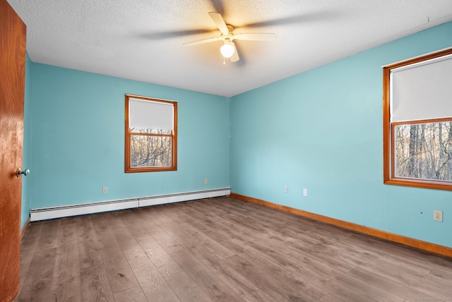 spare room with a textured ceiling, ceiling fan, light wood-type flooring, and baseboard heating