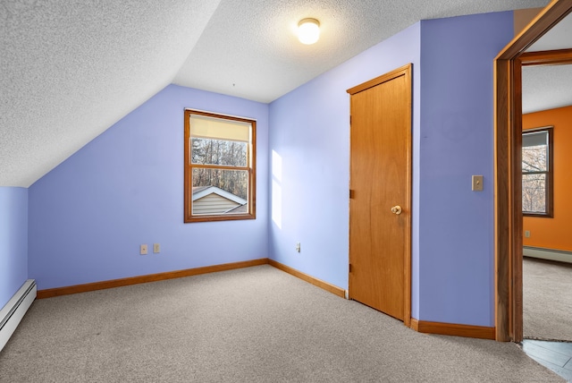 bonus room with a textured ceiling, a baseboard radiator, lofted ceiling, and light colored carpet