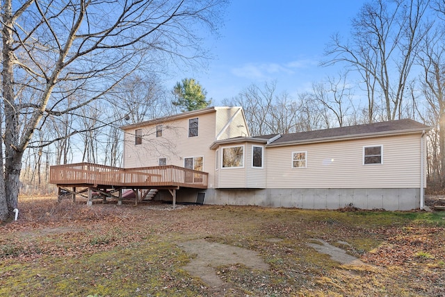 back of property featuring a wooden deck