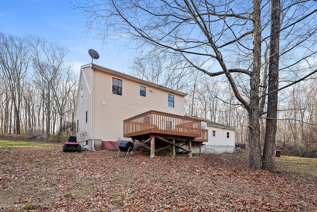 back of house featuring a wooden deck