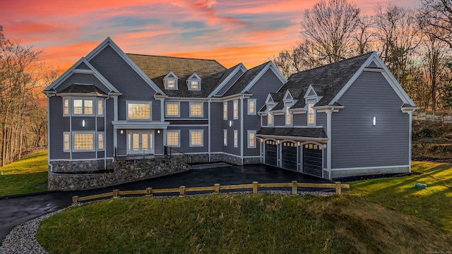 back house at dusk featuring a garage