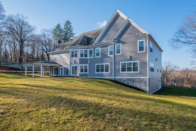 back of house featuring a lawn