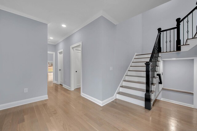 34 Fox Run Rd, Redding, CT 06896 - stairway with ornamental molding, wood finished floors, baseboards, and recessed lighting