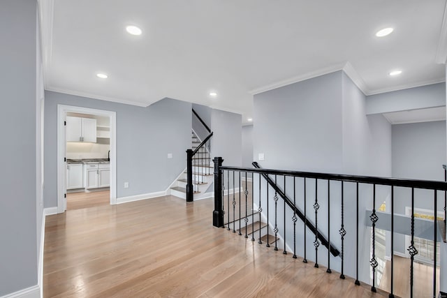 hall featuring light hardwood / wood-style flooring and ornamental molding