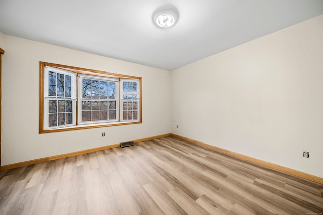 unfurnished room with light hardwood / wood-style floors