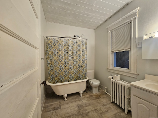 bathroom featuring a tub to relax in, radiator, vanity, hardwood / wood-style floors, and toilet