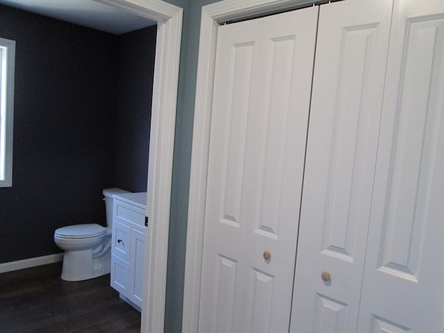 bathroom featuring hardwood / wood-style flooring and toilet