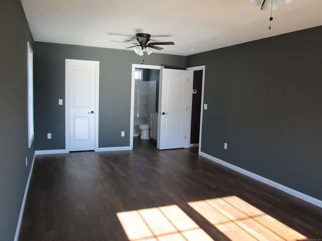 unfurnished bedroom with ensuite bath, ceiling fan, and dark hardwood / wood-style floors