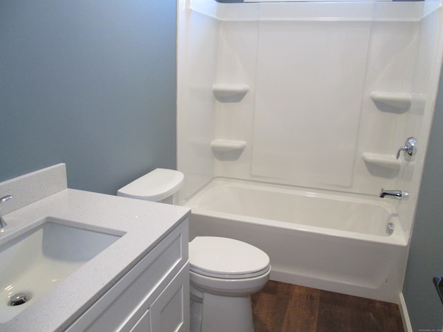 full bathroom with hardwood / wood-style flooring, vanity, toilet, and shower / bath combination