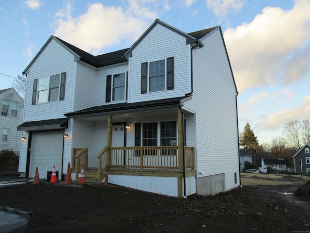 view of front of home featuring a porch and a garage