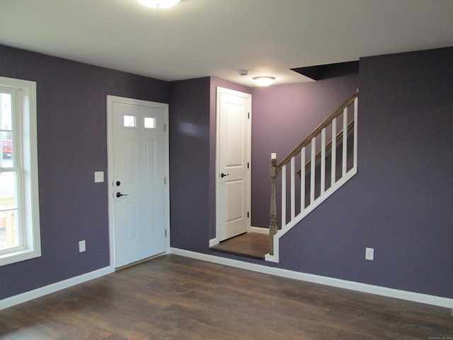 foyer with a wealth of natural light and dark hardwood / wood-style floors