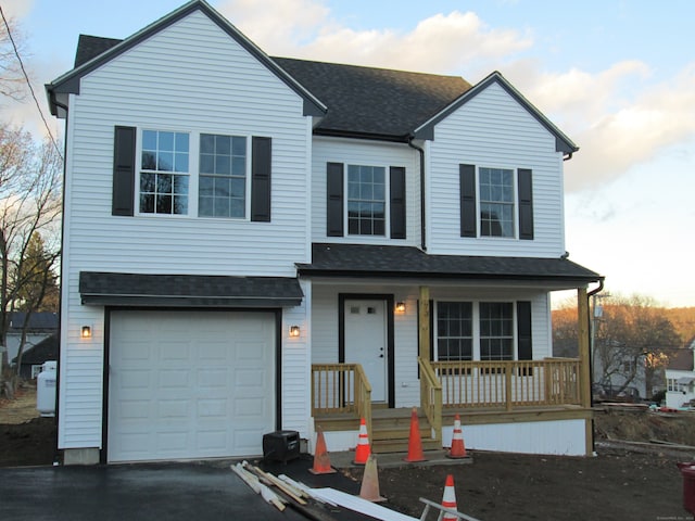 view of front of home featuring covered porch and a garage