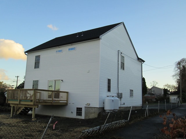 back of property featuring a wooden deck