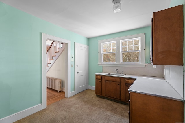 kitchen featuring radiator heating unit and sink