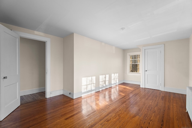 unfurnished room featuring hardwood / wood-style flooring