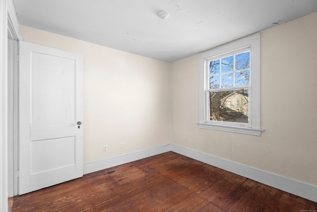 unfurnished room featuring dark hardwood / wood-style flooring