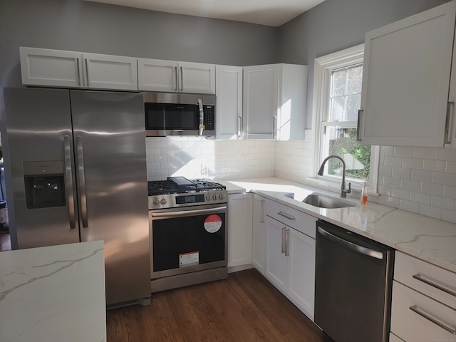 kitchen with sink, white cabinetry, and stainless steel appliances