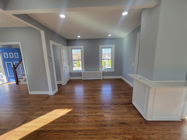 entrance foyer with dark hardwood / wood-style floors and radiator heating unit