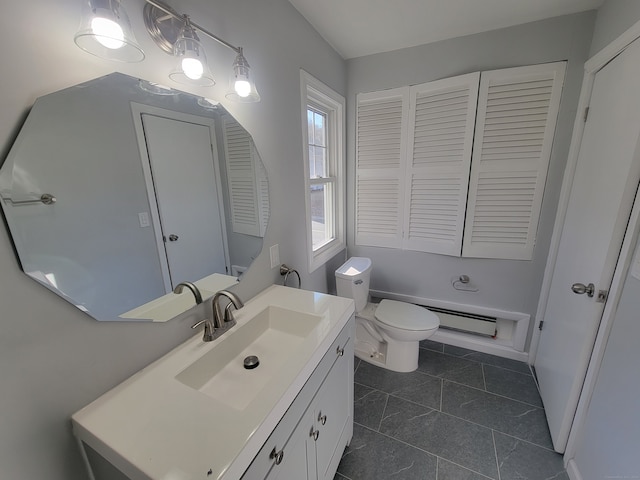 bathroom with tile patterned flooring, vanity, toilet, and a baseboard heating unit