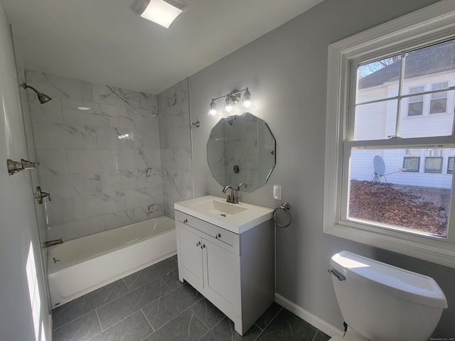 full bathroom featuring vanity, a healthy amount of sunlight, toilet, and tiled shower / bath