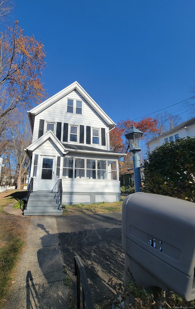 view of front of property with a sunroom