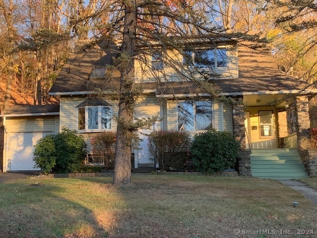 view of front of house with a garage and a front lawn