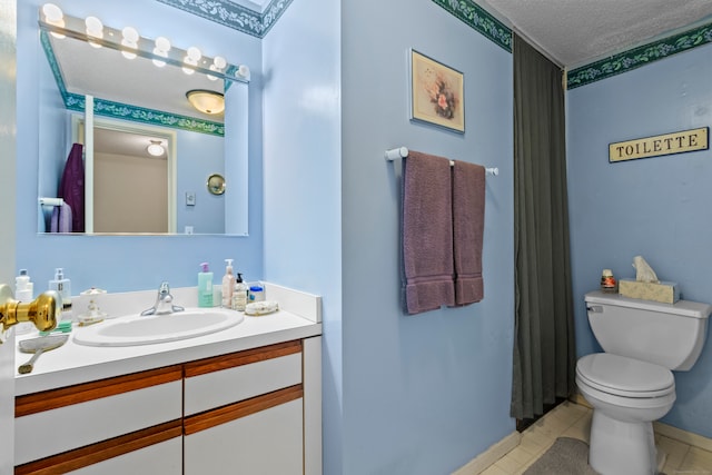 bathroom with tile patterned floors, vanity, toilet, and a textured ceiling