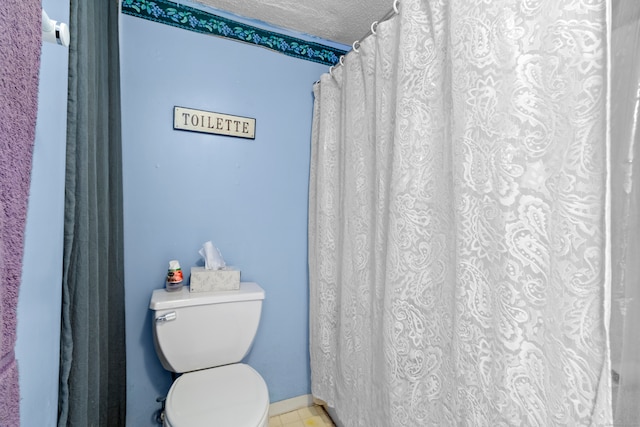 bathroom with a textured ceiling and toilet