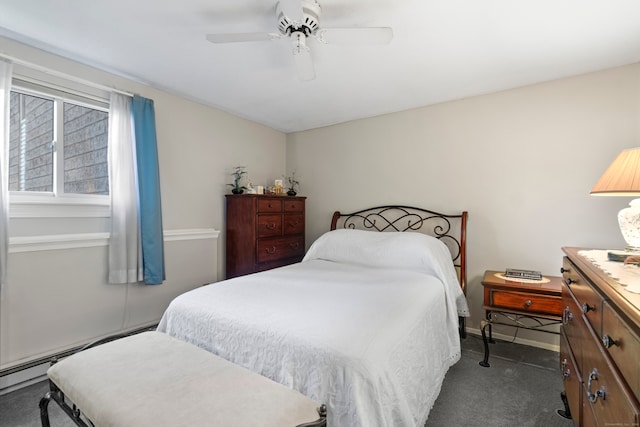 carpeted bedroom featuring ceiling fan and a baseboard heating unit