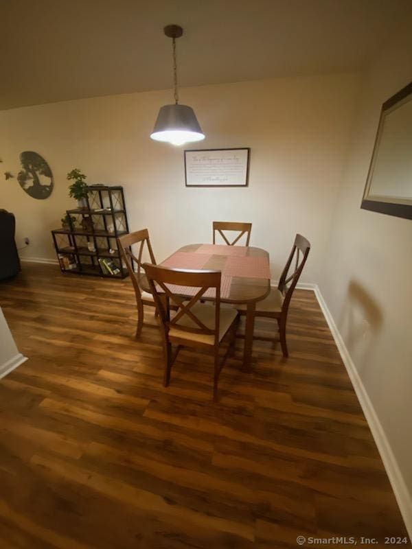 dining room with dark wood-type flooring