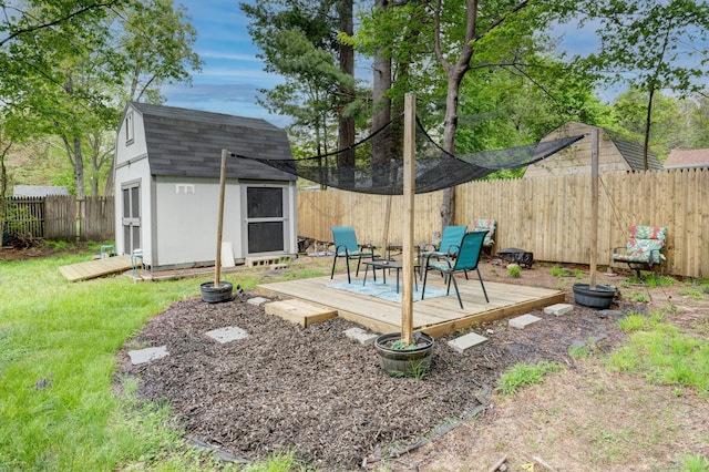 view of yard with a wooden deck and a storage shed