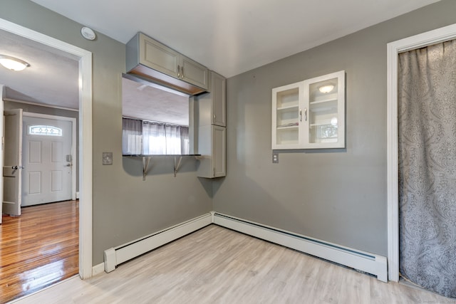 interior space with light hardwood / wood-style floors and a baseboard heating unit