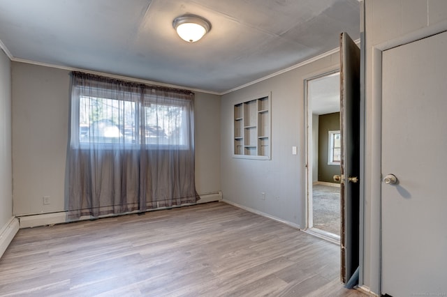 empty room with light hardwood / wood-style floors and ornamental molding