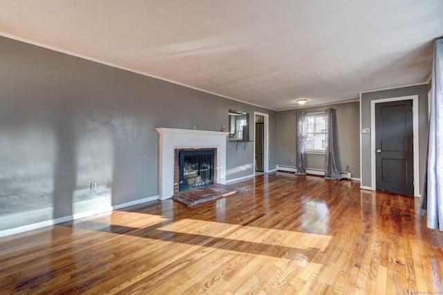 unfurnished living room featuring a fireplace, hardwood / wood-style flooring, and ornamental molding