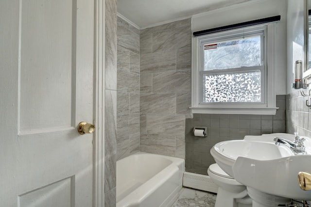 bathroom featuring sink, toilet, baseboard heating, and tile walls