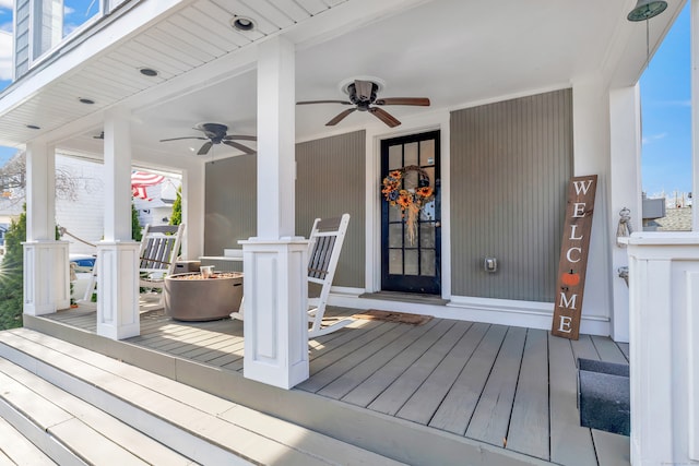 deck with ceiling fan and covered porch