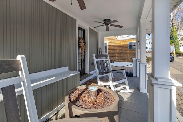 wooden terrace featuring a porch and ceiling fan