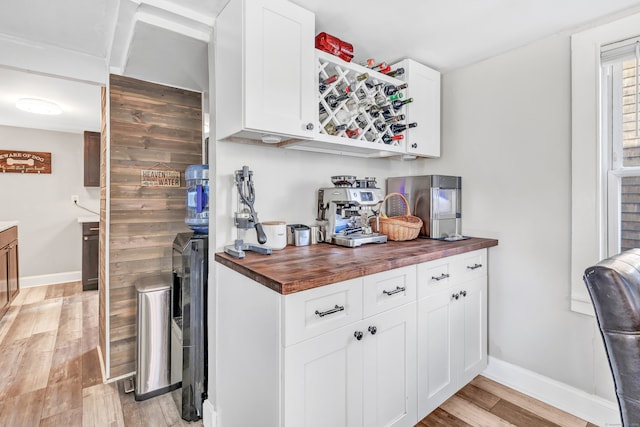 interior space featuring wood counters, white cabinetry, and light hardwood / wood-style flooring