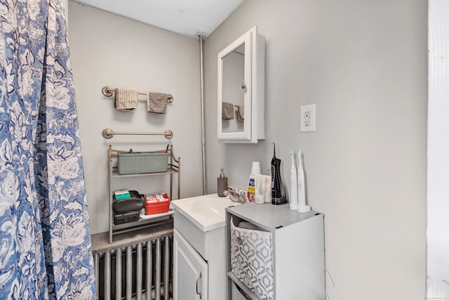 bathroom featuring radiator heating unit and vanity