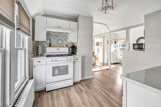 kitchen featuring decorative backsplash, white cabinetry, plenty of natural light, and white range with gas cooktop