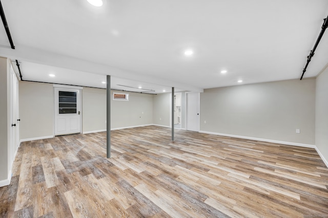 basement with light hardwood / wood-style floors