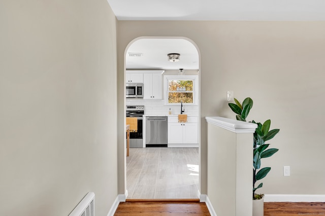 hall with light hardwood / wood-style flooring